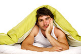 Man in bed under a green duvet