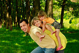 young family playing in the plane on the nature