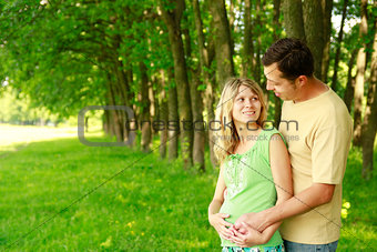 A young pregnant couple on nature