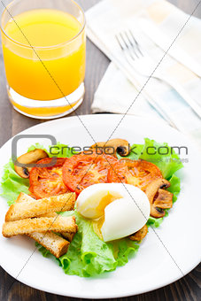 Light breakfast with soft egg, tomato and croutons
