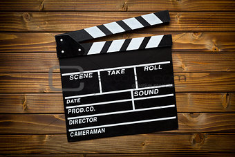 clapper board on wooden table