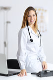Beautiful female doctor in her consultation