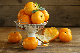 fresh ripe orange mandarins (tangerines) on a wooden table