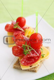 Canapes with cheese and salami