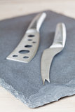 Cheese knives on slate board