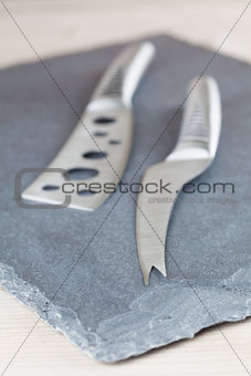 Cheese knives on slate board