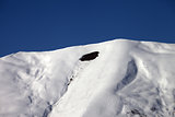 Trace of avalanche on off-piste slope in sunny day