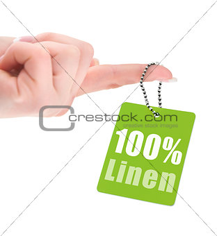 female hand with hundred percent linen tag