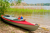 folding red canoe on the shore of Lake