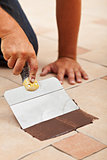 Applying the joint material on ceramic floor tiles