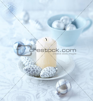 Candle and glass ornaments on a christmas table