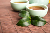 A cup of green tea with freh leaves