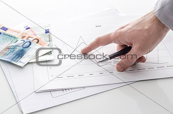 Man pointing at financial report