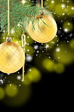 Pine branch with golden Christmas balls.