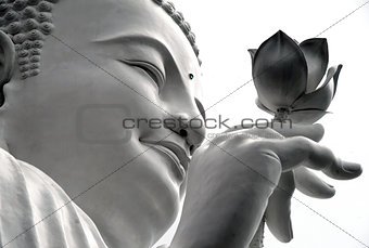 white Buddha with a lotus in his hand