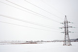 power line in the middle of the field in winter