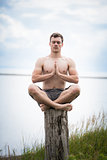 Young Adult Doing Yoga on a Stump in Nature