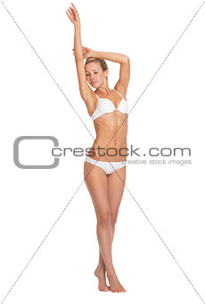 Full length portrait of relaxed young woman in lingerie