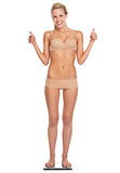 Full length portrait of happy young woman in lingerie standing o