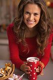 Happy young woman in red dress having christmas snack