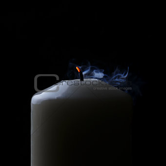 extinguished candle with blue smoke