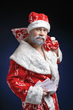 Portrait of Santa, who holds the money on a blue background