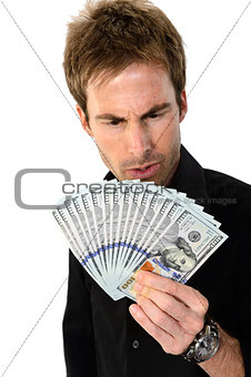 Young man holding hundred dollar bills