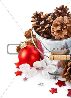 pinecone in bucket with christmas tinsel