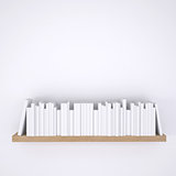 Wooden shelf with books on white wall background