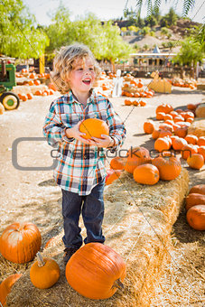 Little Boy Holding His Pumpkin at a Pumpkin Patch 