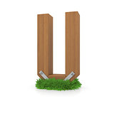 Wooden letter U in the grass