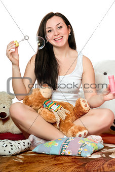 Cheerful girl blow bubbles. Isolated