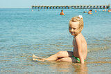 Little girl on the coastal seawater