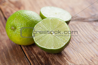 Limes on wood background