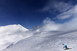 Snowboarder on ski slope at nice day
