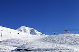 Gondola lift and ski slope at nice day