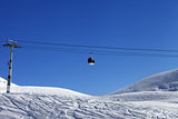 Gondola lift and off piste slope at nice day