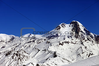 Mount Kazbek at sun winter day