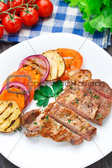 Steak with grilled vegetables on a plate