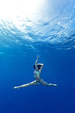 girl making yoga in the sea