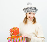 Charming smiling girl holding a gift box