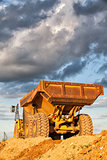 Heavy mining truck at sunset