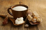 different kinds of sugar - brown, white, refined sugar on a wooden background