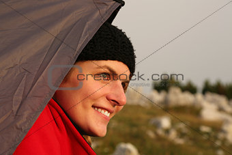 Young woman watching the sunset while camping