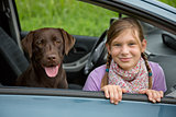 Child and dog in a car