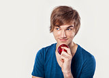 Young man eating a apple