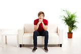 Young man sitting on the couch