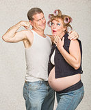 Man Showing Biceps to Pregnant Woman