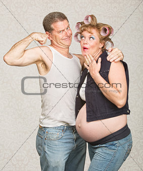 Man Showing Biceps to Pregnant Woman