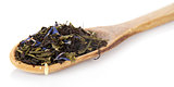 Fragrant dry tea leaves in wooden spoon